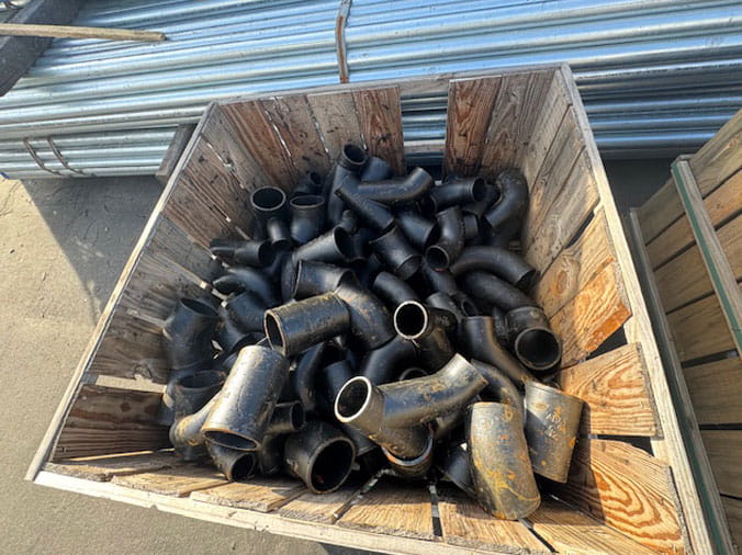 Bin full of black plumbing fittings at Visalia Pipe & Supply